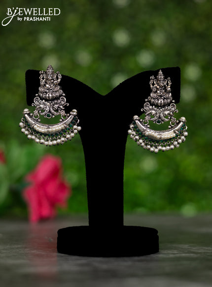 Oxidised earrings ganesha design with emerald stones and pearl hangings