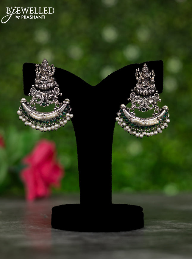 Oxidised earrings ganesha design with emerald stones and pearl hangings