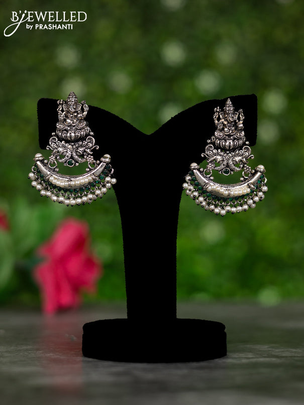 Oxidised earrings ganesha design with emerald stones and pearl hangings