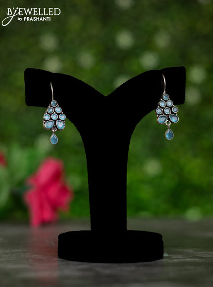 Oxidised hanging type earrings with ice blue stones