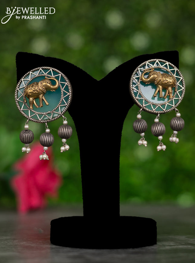 Oxidised earrings elephant design with mint green stones and pearl hangings