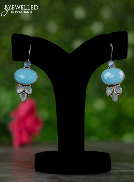Oxidised hanging type earrings with ice blue stones