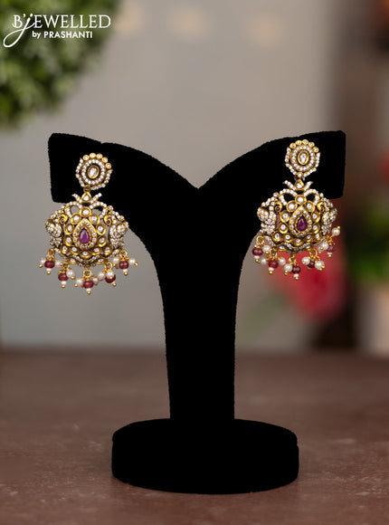 Earrings with ruby & cz stones and pearl hangings in victorian finish