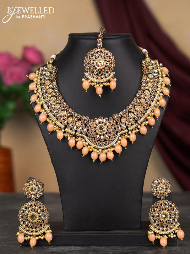 Kundan necklace with peach shade beads hangings and maang tikka