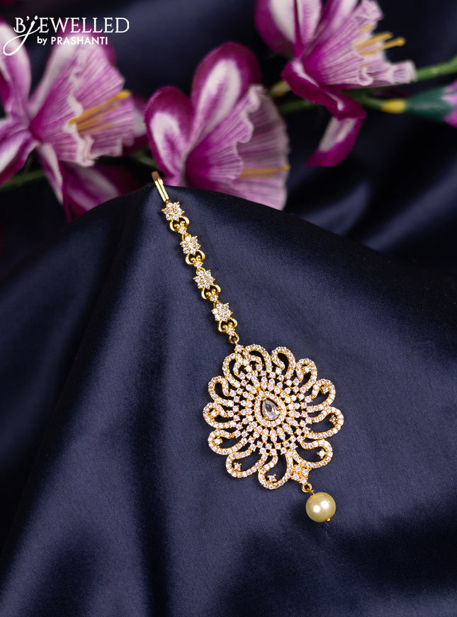 Zircon maang tikka with cz stones and pearl hanings in gold finish