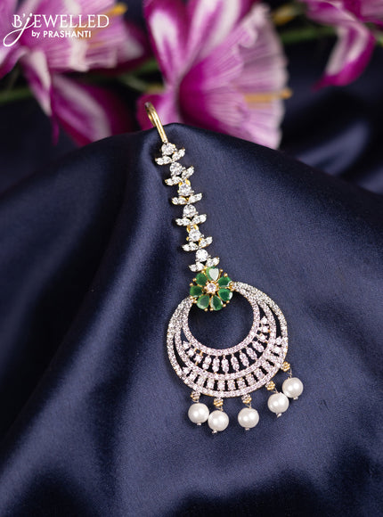 Zircon maang tikka with emerald & cz stones and pearl hanings in gold finish