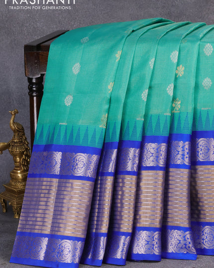 Kuppadam silk cotton saree teal blue and blue with allover vairosi pattern & zari buttas and temple design long silver zari woven border