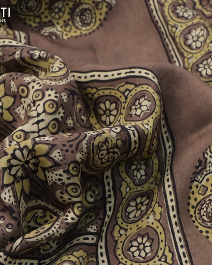 Dola silk saree chiku shade with allover ajrakh prints and zari woven floral border - {{ collection.title }} by Prashanti Sarees