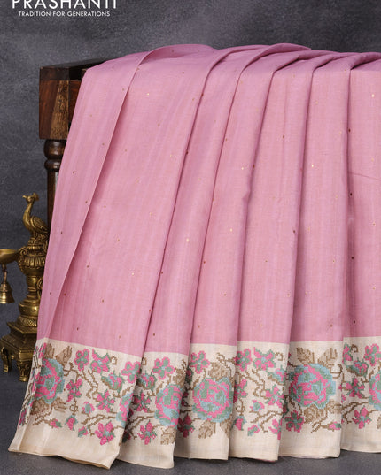 Tussar silk saree pastel pink and cream with allover zari buttas and floral design cross stitched embroidery border