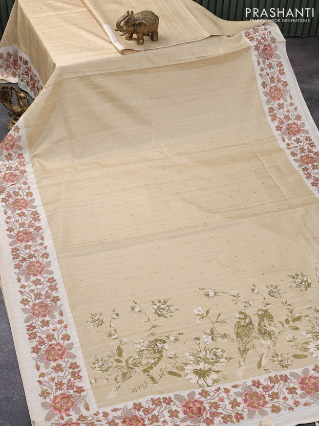 Tussar silk saree beige and cream with allover zari buttas and floral design cross stitched embroidery border