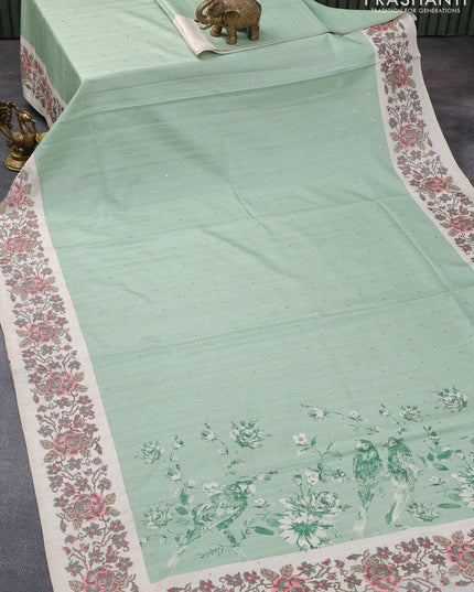 Tussar silk saree pastel green and cream with allover zari buttas and floral design cross stitched embroidery border
