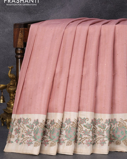Tussar silk saree peach pink and cream with allover zari buttas and floral design cross stitched embroidery border