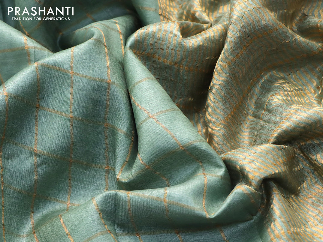 Pure tussar silk saree pastel green and peach orange with allover zari checked pattern and zari woven border and Kalamkari printed blouse