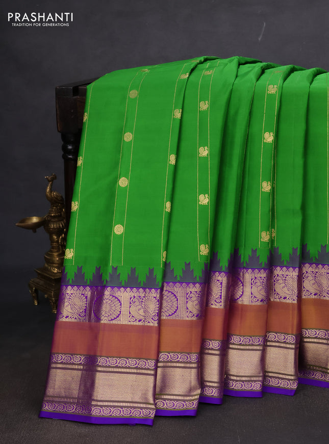 Pure gadwal silk saree green and violet with allover zari weaves & Buttas and temple design rettapet zari woven border