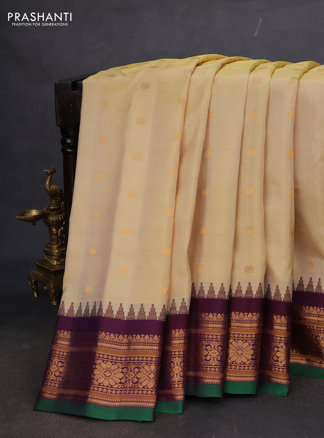 Pure gadwal silk saree pale yellow and wine shade with floral zari woven buttas and temple design zari woven border
