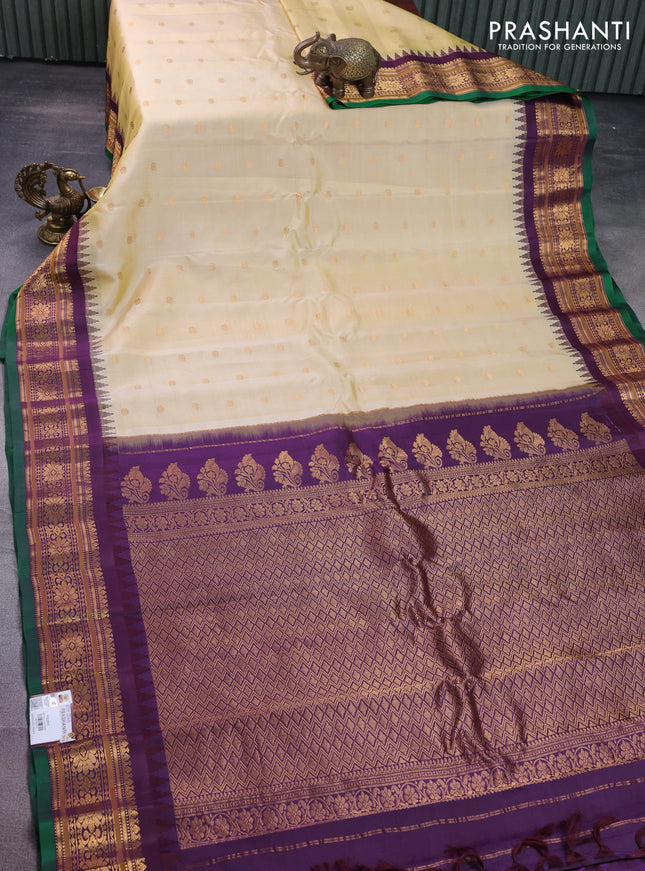 Pure gadwal silk saree pale yellow and wine shade with floral zari woven buttas and temple design zari woven border