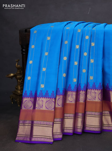 Pure gadwal silk saree cs blue and violet with allover zari weaves & buttas and long temple design rettapet zari woven border