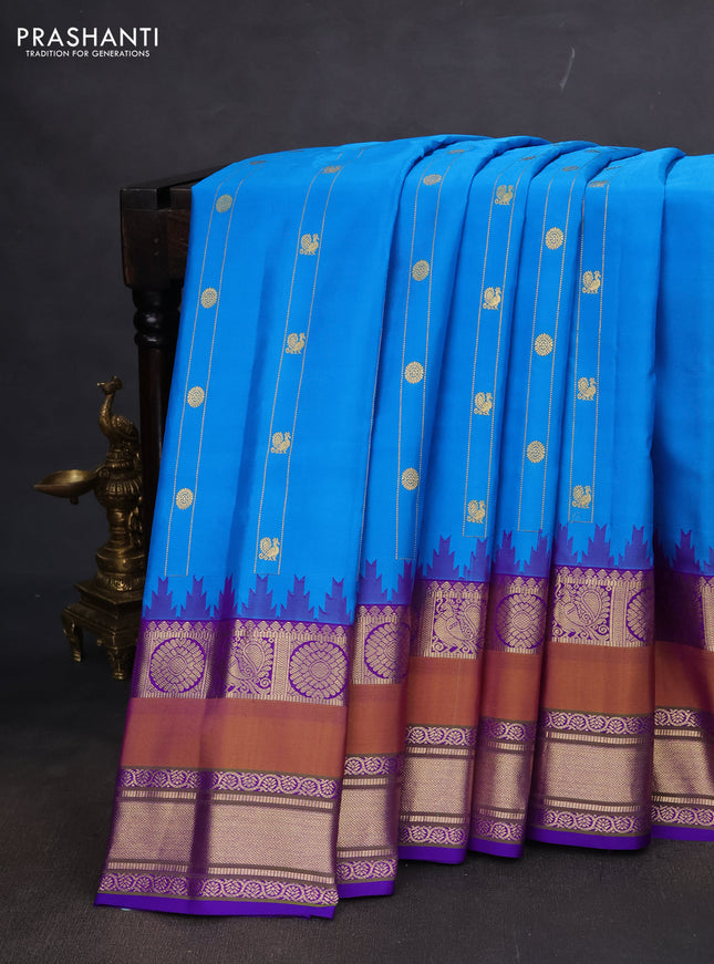 Pure gadwal silk saree cs blue and violet with allover zari weaves & buttas and long temple design rettapet zari woven border
