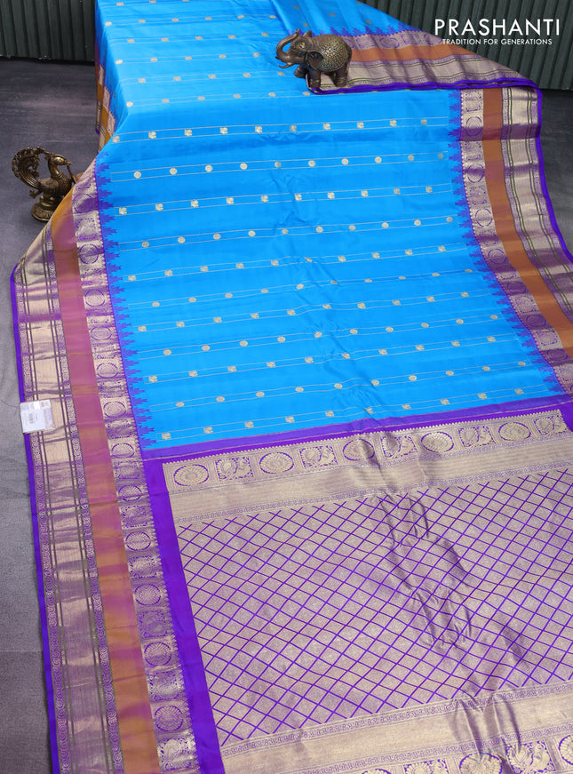 Pure gadwal silk saree cs blue and violet with allover zari weaves & buttas and long temple design rettapet zari woven border