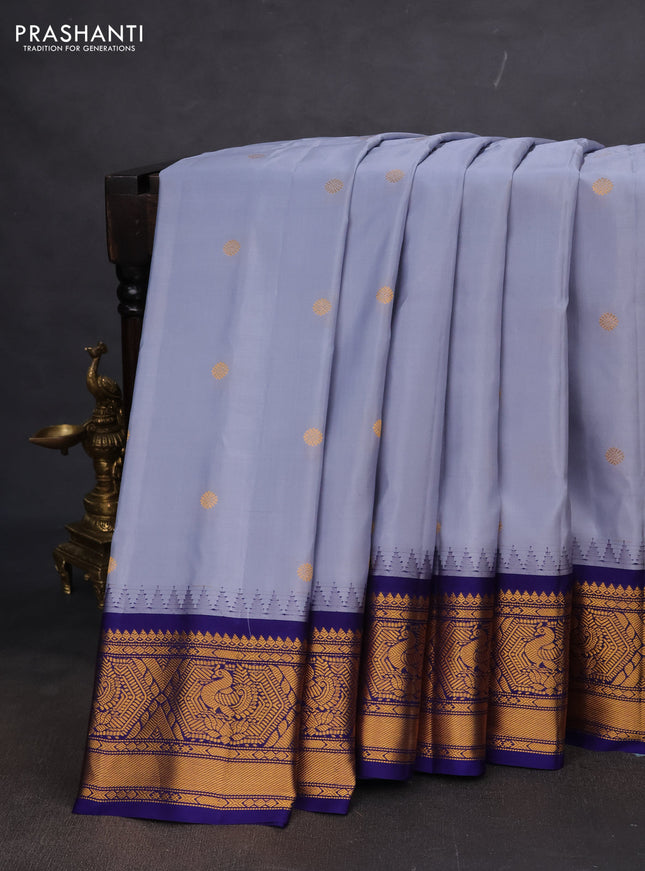 Pure gadwal silk saree grey and blue with zari woven buttas and temple design zari woven korvai border