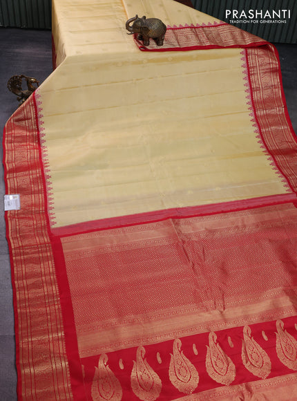 Pure gadwal silk saree pale yellow and red with paisley zari woven buttas and temple design zari woven border