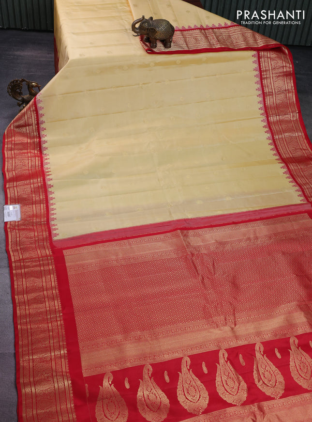 Pure gadwal silk saree pale yellow and red with paisley zari woven buttas and temple design zari woven border
