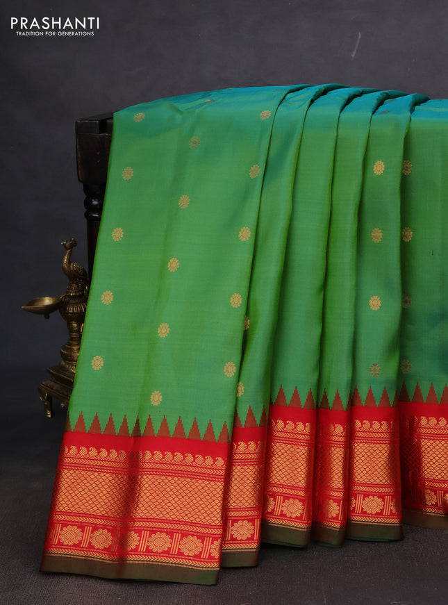 Pure gadwal silk saree dual shade of green and red with floral zari woven buttas and temple design zari woven border