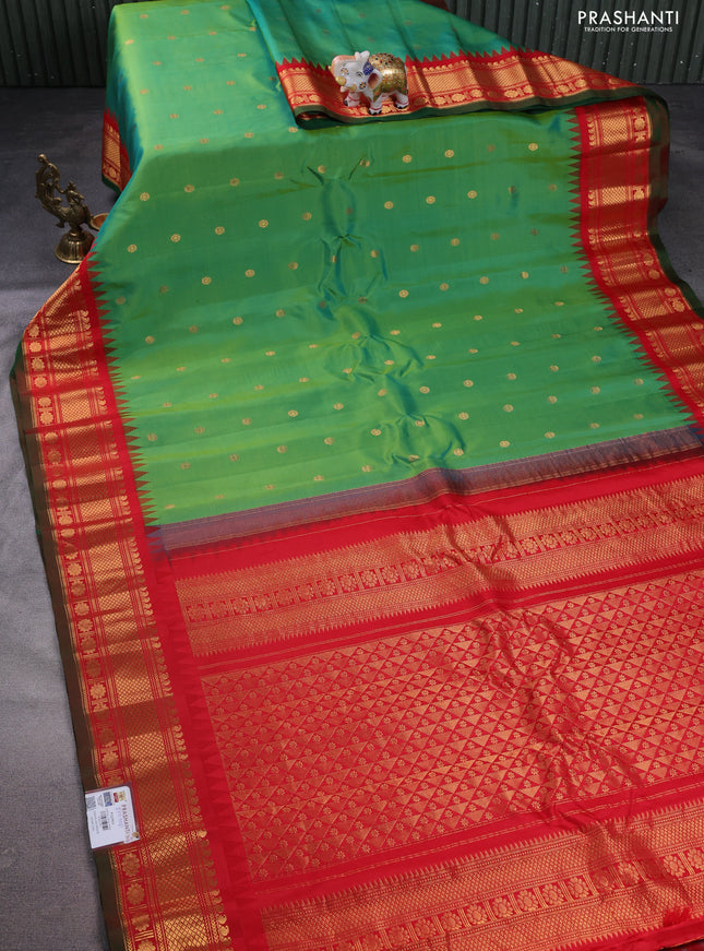Pure gadwal silk saree dual shade of green and red with floral zari woven buttas and temple design zari woven border