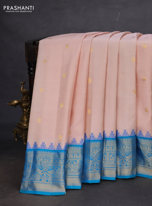 Pure gadwal silk saree pastel peach and dual shade of teal blue with annam zari woven buttas and temple design zari woven border