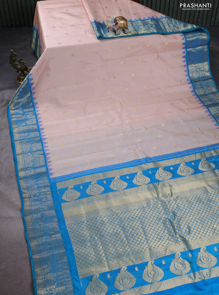 Pure gadwal silk saree pastel peach and dual shade of teal blue with annam zari woven buttas and temple design zari woven border