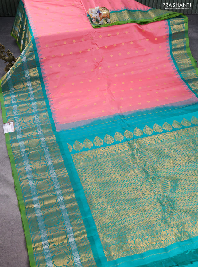 Pure gadwal silk saree pastel peach pink and teal green with floral zari woven buttas and long temple design zari woven border