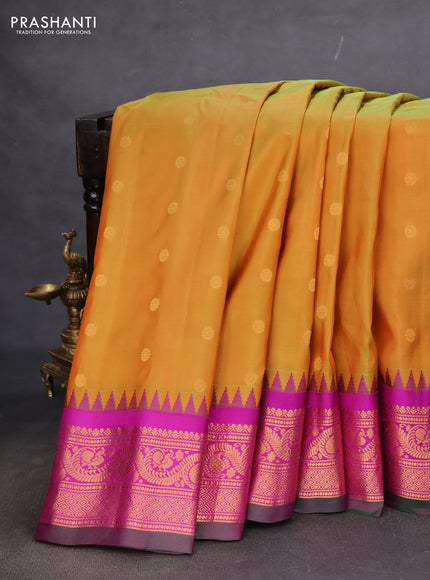 Pure gadwal silk saree dual shade of mustard and purple with floral zari woven buttas and temple design zari woven border