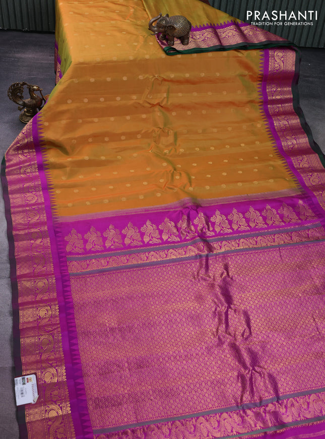 Pure gadwal silk saree dual shade of mustard and purple with floral zari woven buttas and temple design zari woven border