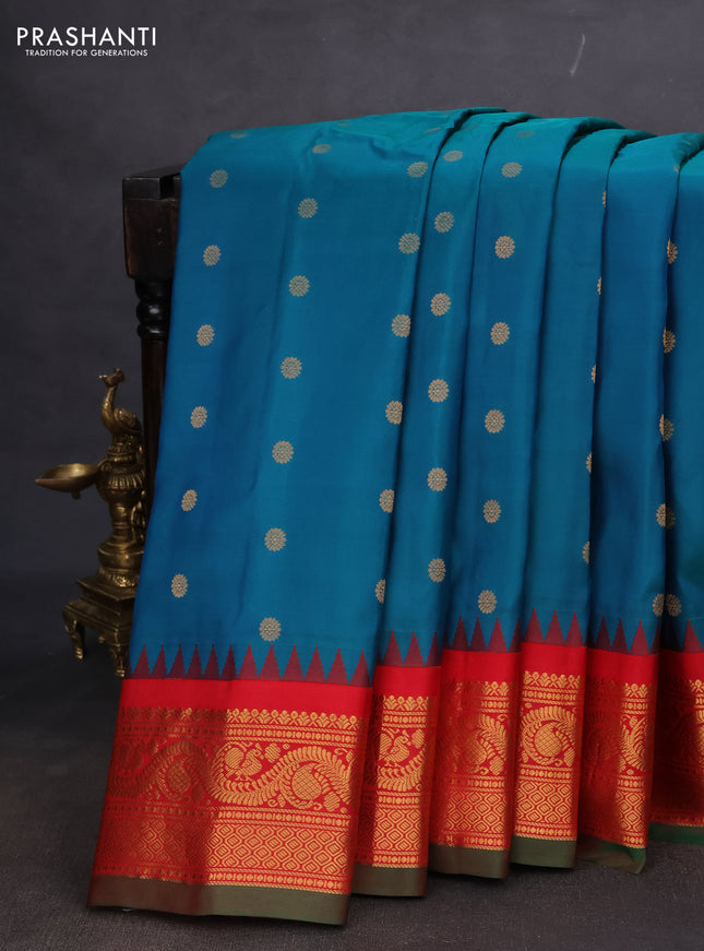 Pure gadwal silk saree dual shade of teal bluish green and red with floral zari woven buttas and temple design zari woven border