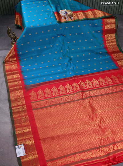 Pure gadwal silk saree dual shade of teal bluish green and red with floral zari woven buttas and temple design zari woven border