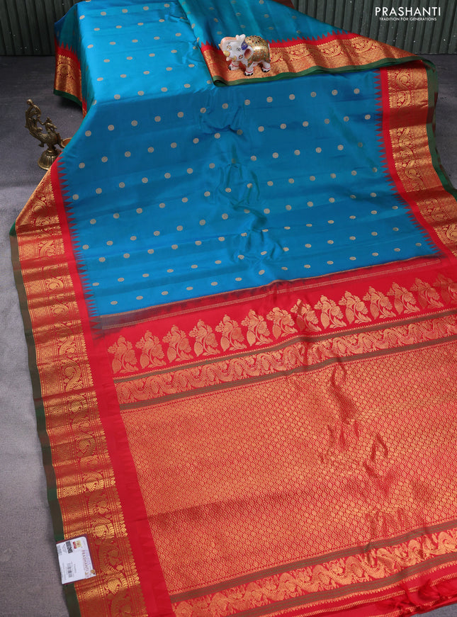 Pure gadwal silk saree dual shade of teal bluish green and red with floral zari woven buttas and temple design zari woven border