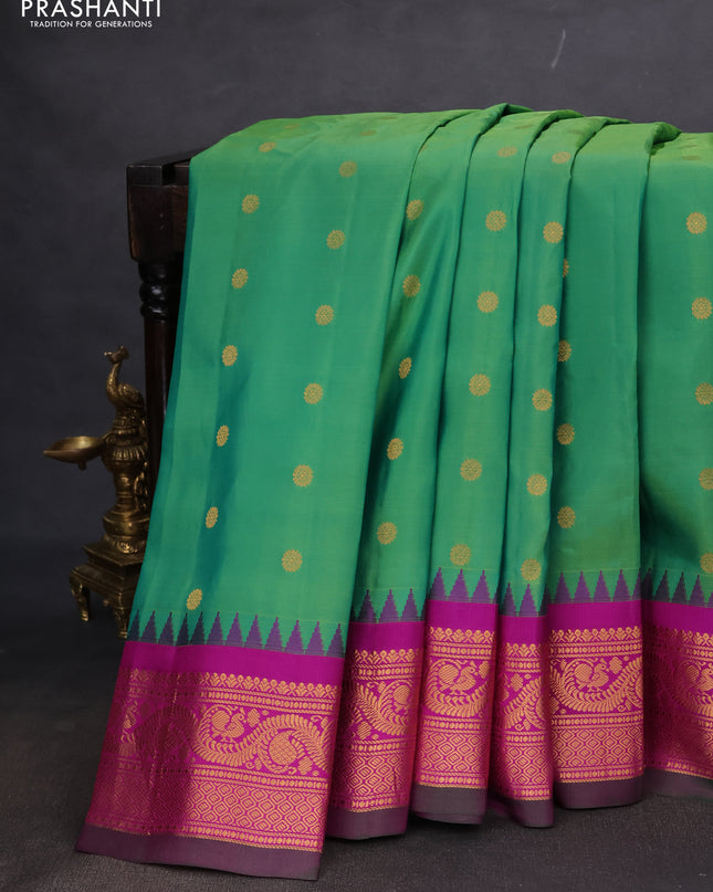 Pure gadwal silk saree green and purple with allover zari woven buttas and temple design zari woven border