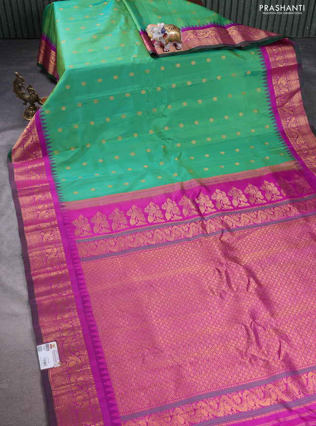 Pure gadwal silk saree green and purple with allover zari woven buttas and temple design zari woven border