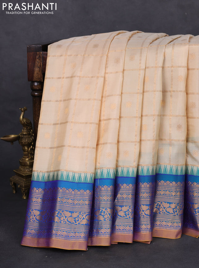 Pure gadwal silk saree cream and dual shade of blue with allover zari checks & buttas and temple design zari woven korvai border