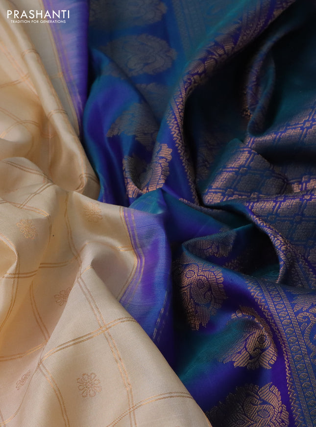 Pure gadwal silk saree cream and dual shade of blue with allover zari checks & buttas and temple design zari woven korvai border