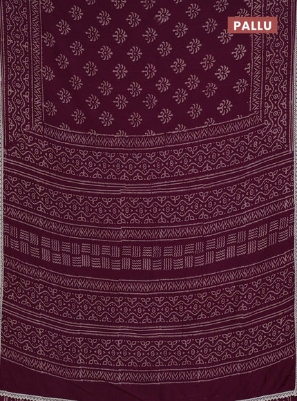 Semi pashmina silk saree wine shade and cream with allover butta prints and crocia lace work border
