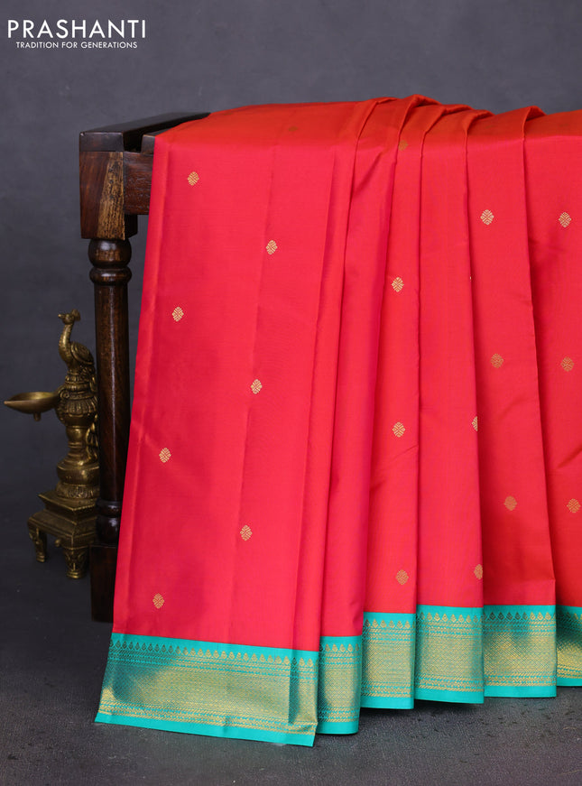 Pure kanchipuram silk saree dual shade of pinkish orange and teal green with zari woven buttas and zari woven korvai border