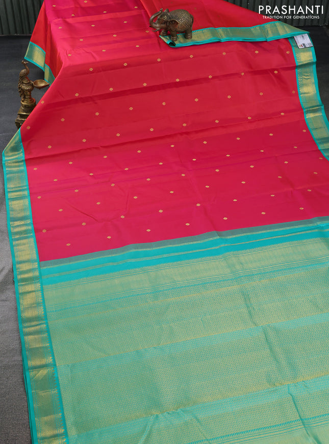 Pure kanchipuram silk saree dual shade of pinkish orange and teal green with zari woven buttas and zari woven korvai border