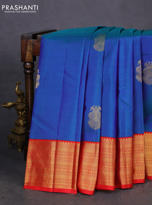 Pure kanchipuram silk saree dual shade of blue and red with peacock zari woven buttas and zari woven korvai border