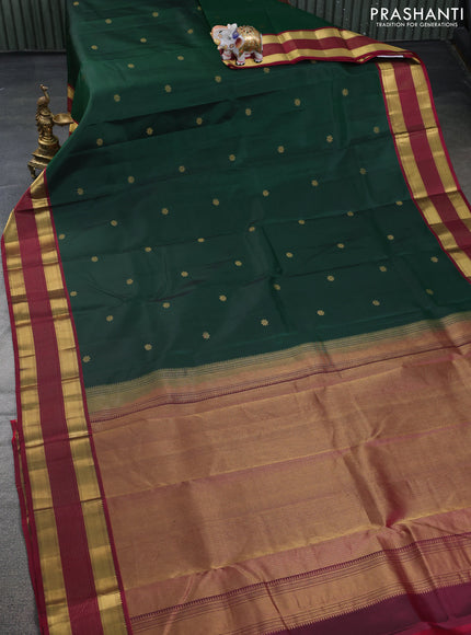 Pure kanchipuram silk saree dark green and dark magenta pink with zari woven floral buttas and zari woven border