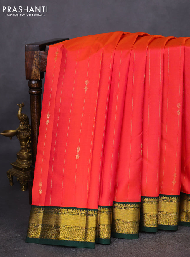 Pure kanchipuram silk saree dual shade of pinkish orange and green with allover zari stripes & zari buttas and zari woven korvai border