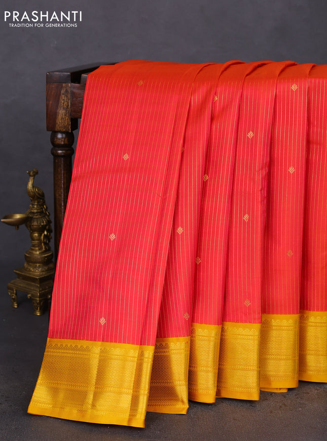 Pure kanchipuram silk saree dual shade of pinkish orange and yellow with allover zari stripes & zari buttas and zari woven korvai border