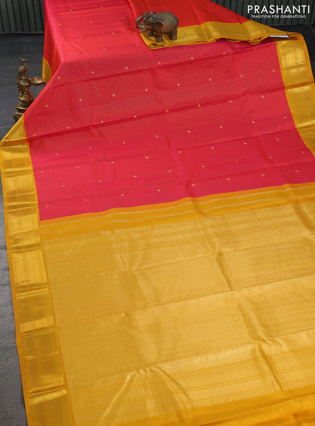 Pure kanchipuram silk saree dual shade of pinkish orange and yellow with allover zari stripes & zari buttas and zari woven korvai border