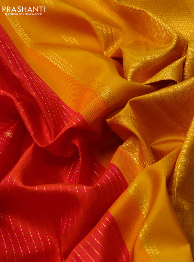 Pure kanchipuram silk saree dual shade of pinkish orange and yellow with allover zari stripes & zari buttas and zari woven korvai border