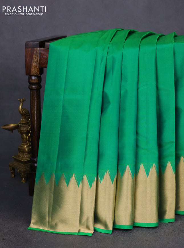 Pure kanchipuram silk saree cream with plain body and temple design zari woven border